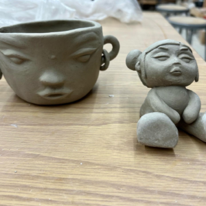 clay figures of face pot and baby doll